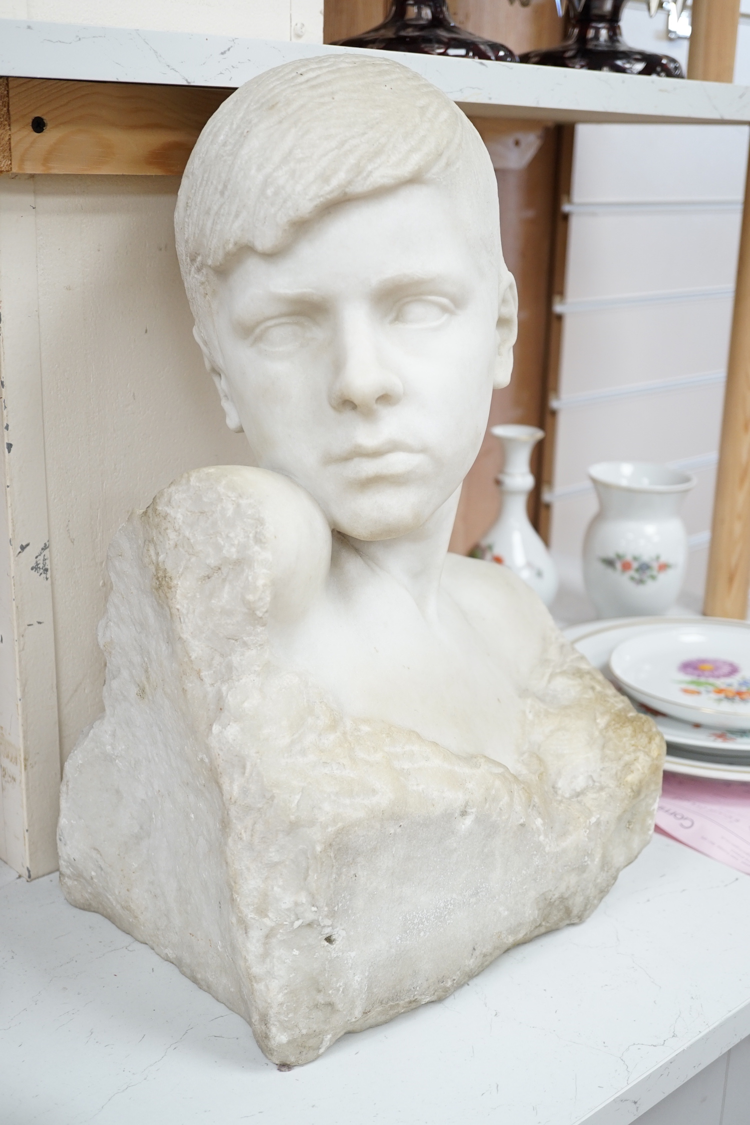 A carved Carrara marble portrait bust of a youth, unsigned, 46cm